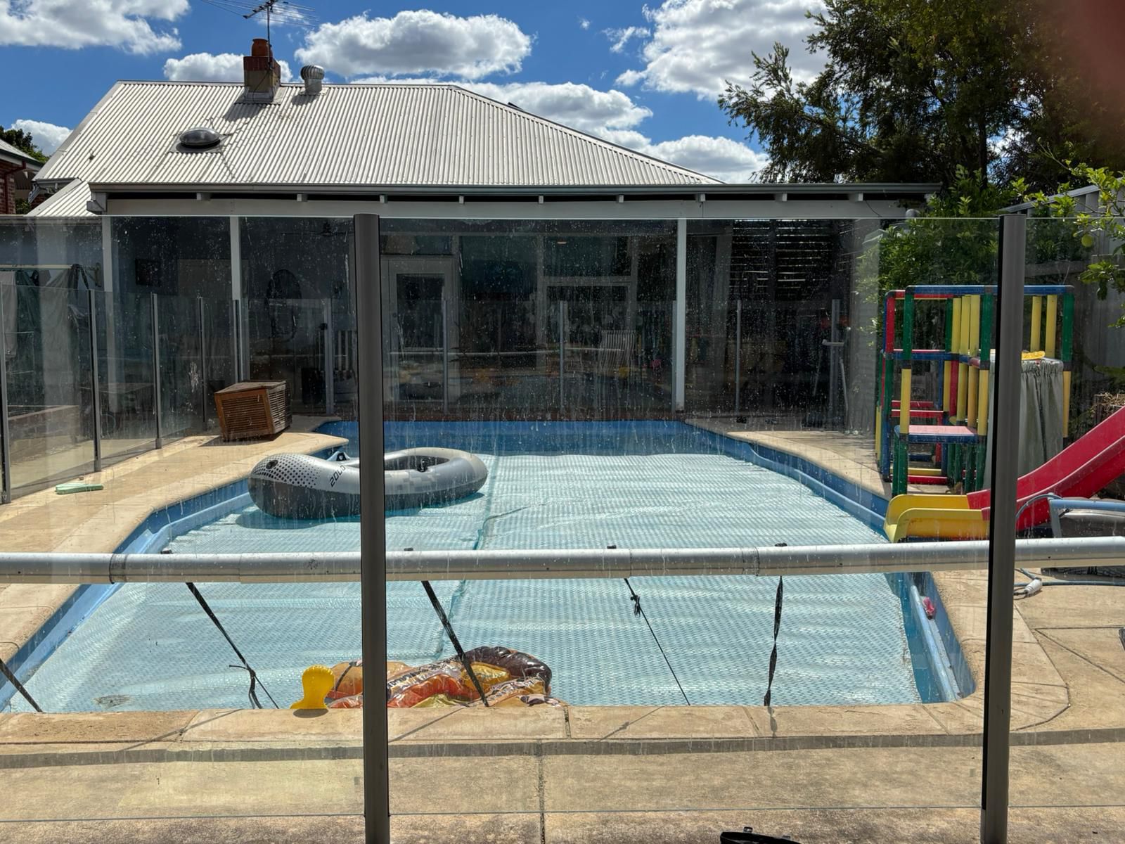 Dirty pool glass panels before cleaning in Perth